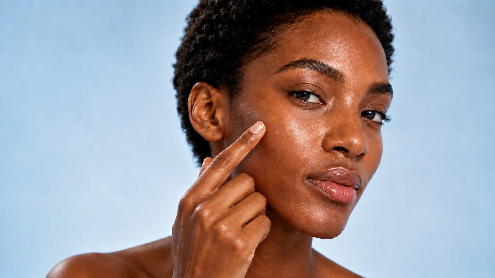 The same fictional woman applying a small serum bead to her cheek.